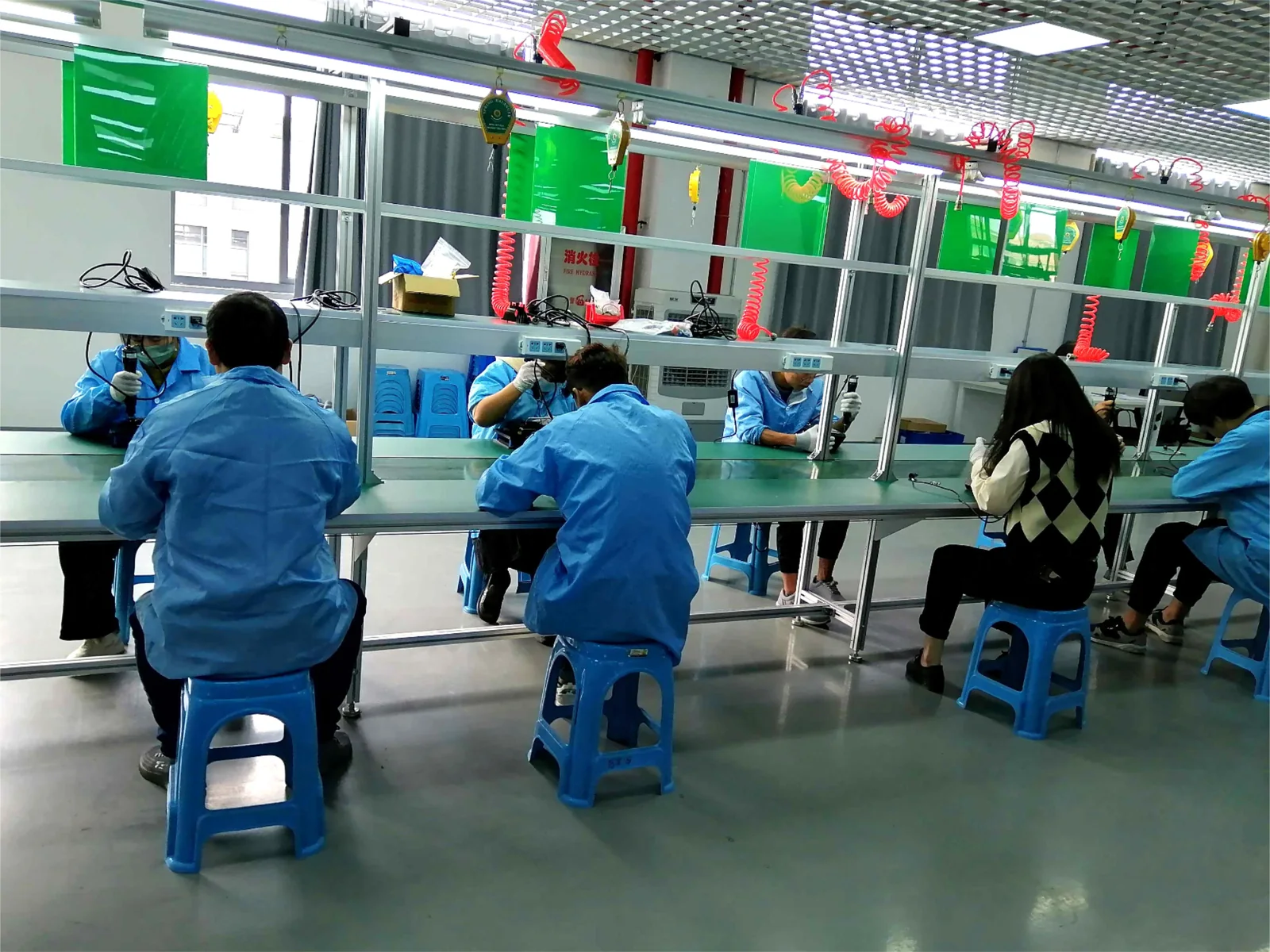 Operators working at assembly stations on the Jitian Intelligent production line in Xuzhou, Jiangsu