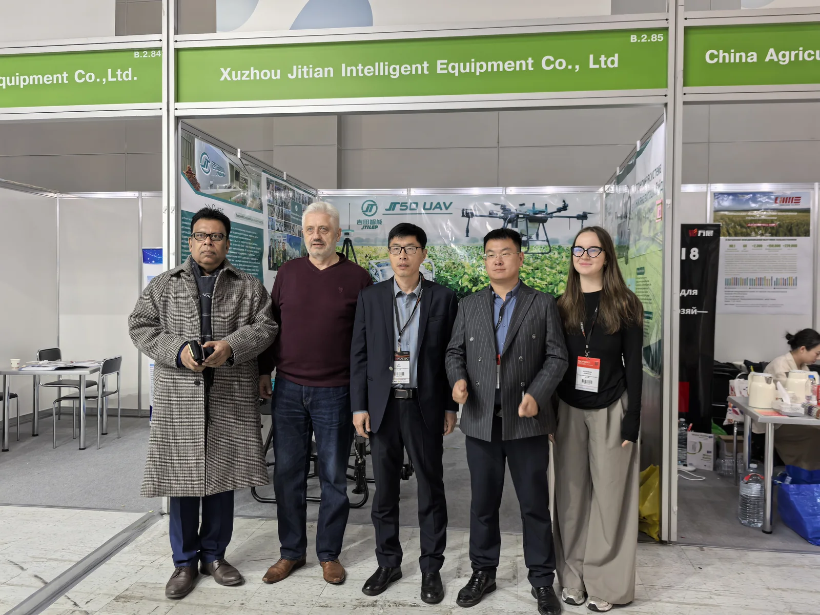 JTILEP team meeting overseas buyers at an agricultural machinery exhibition stand