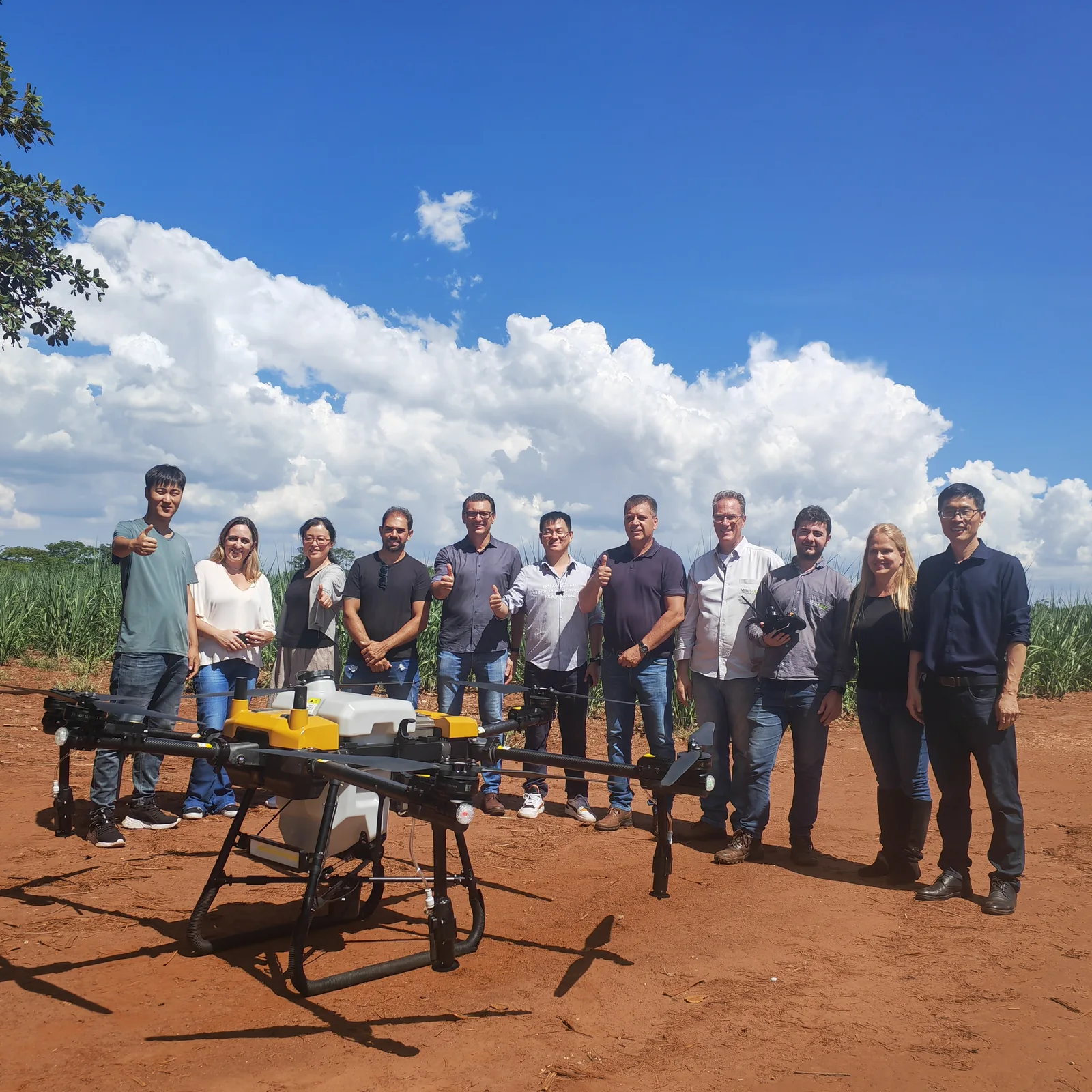 The Jitian Intelligent field team with an agricultural spray drone during a field trial in Jiangsu