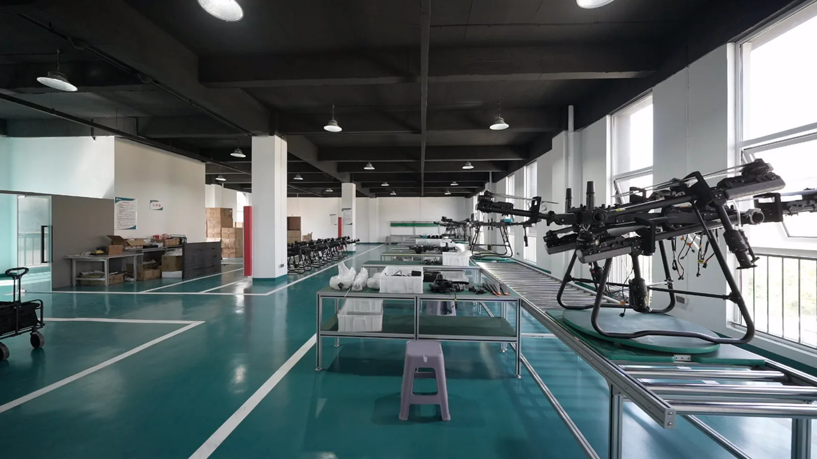A row of JT-80 spray drones staged side by side on a service bench before delivery